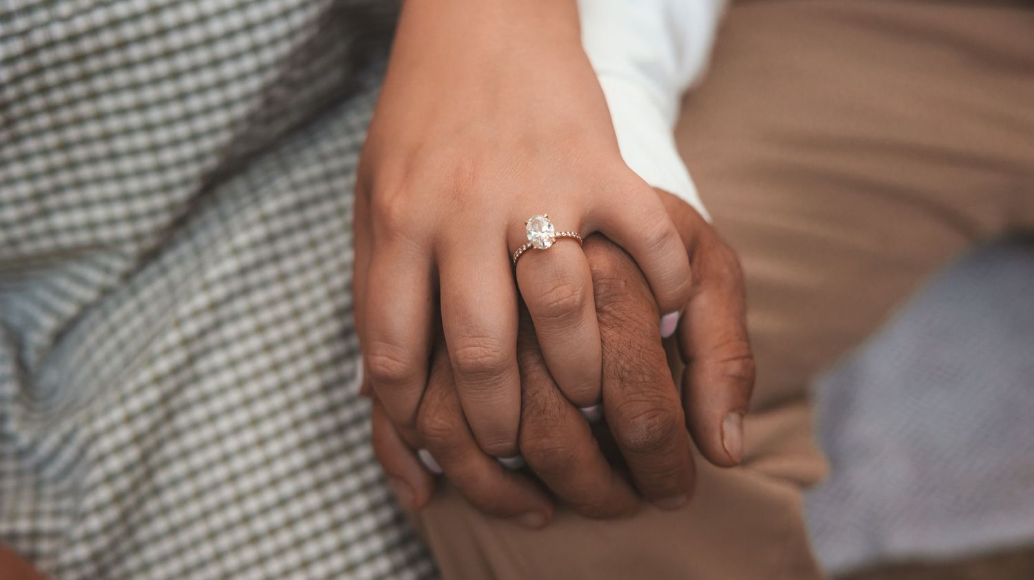 Close-up shots showing hands with wedding rings and an engagement ring in various intimate poses.