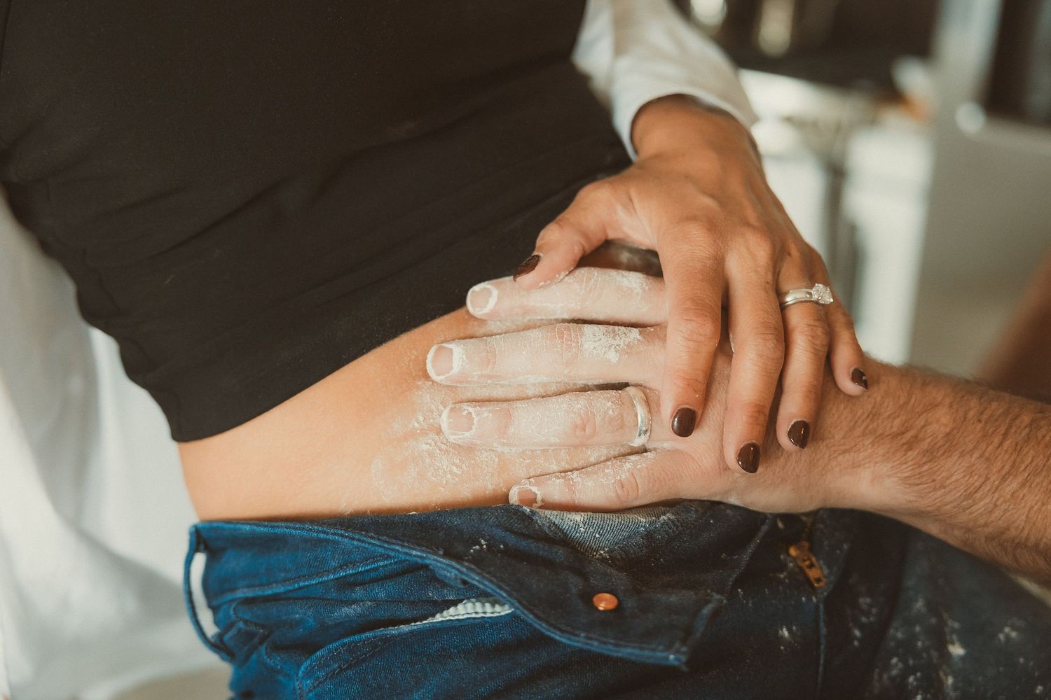 Close-up macro shots of hands with engagement rings and jewelry on fingers against various textured backgrounds.