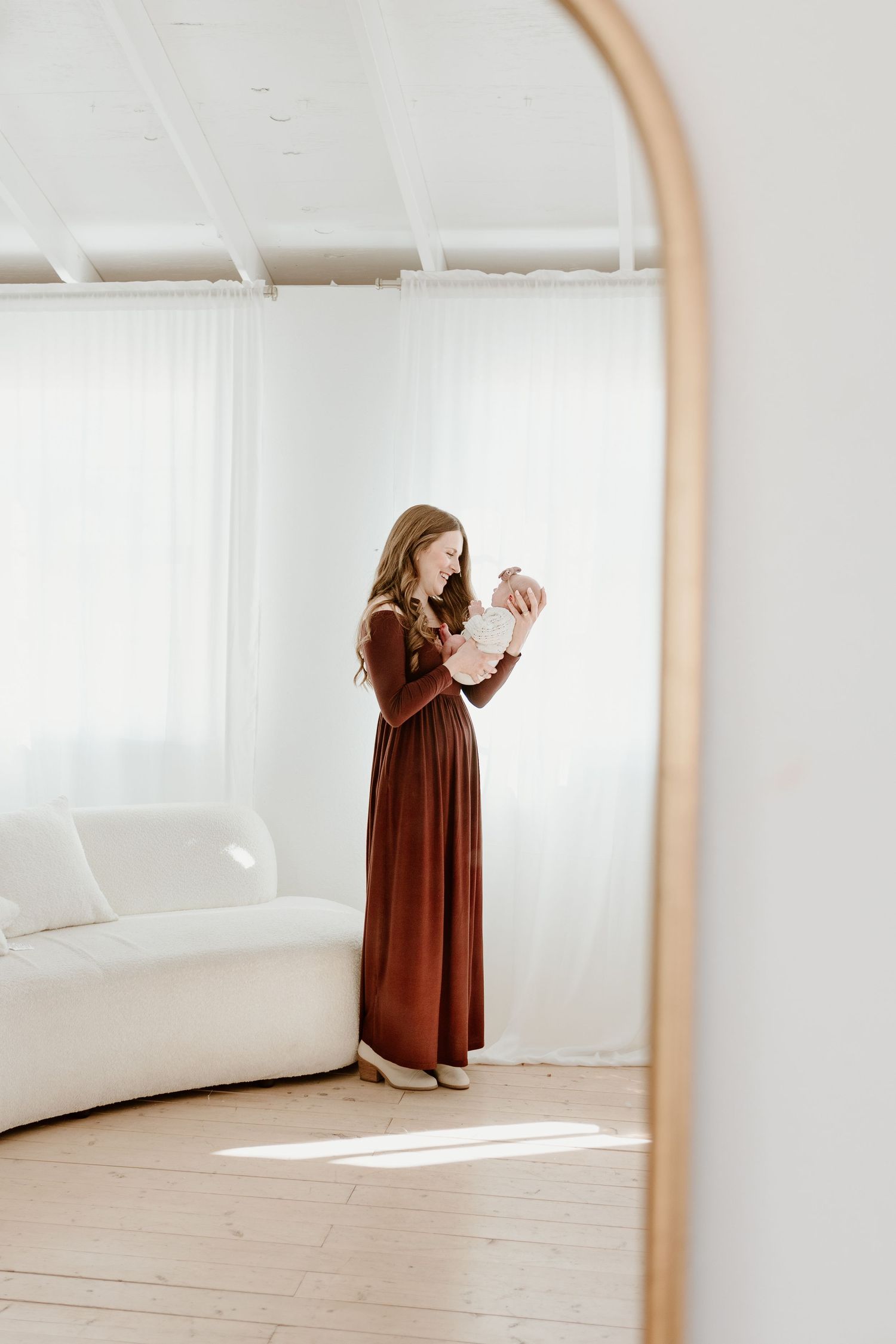 mom and newborn baby in mirror