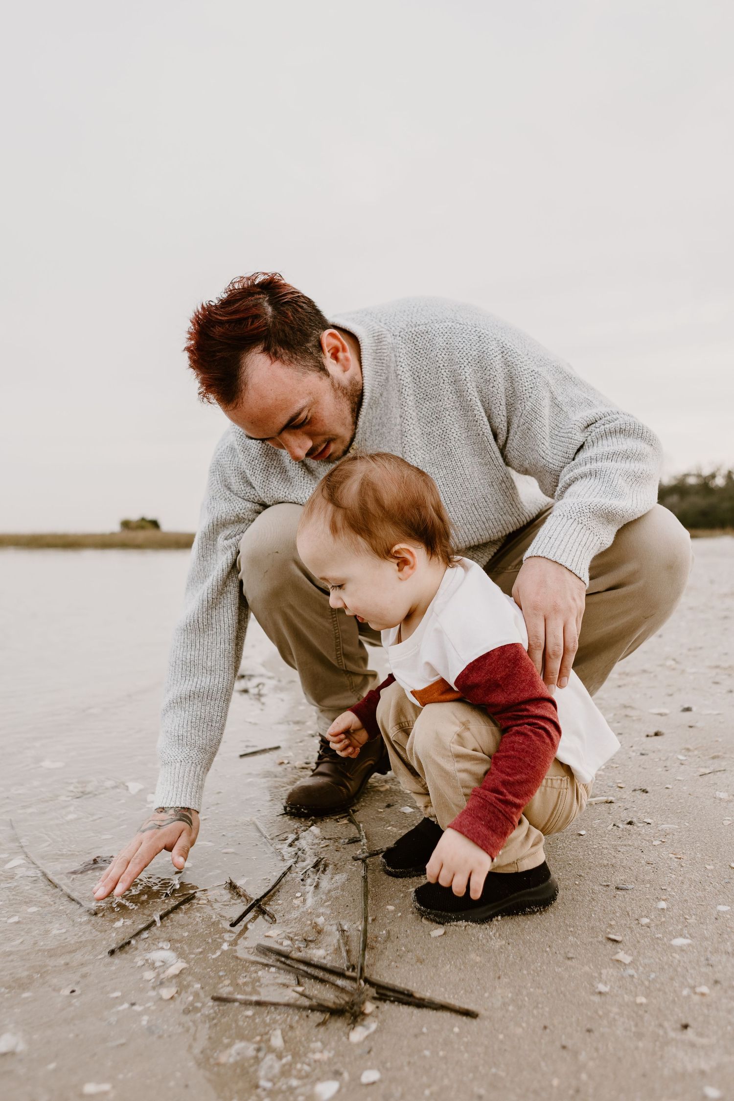 father and son playing in water