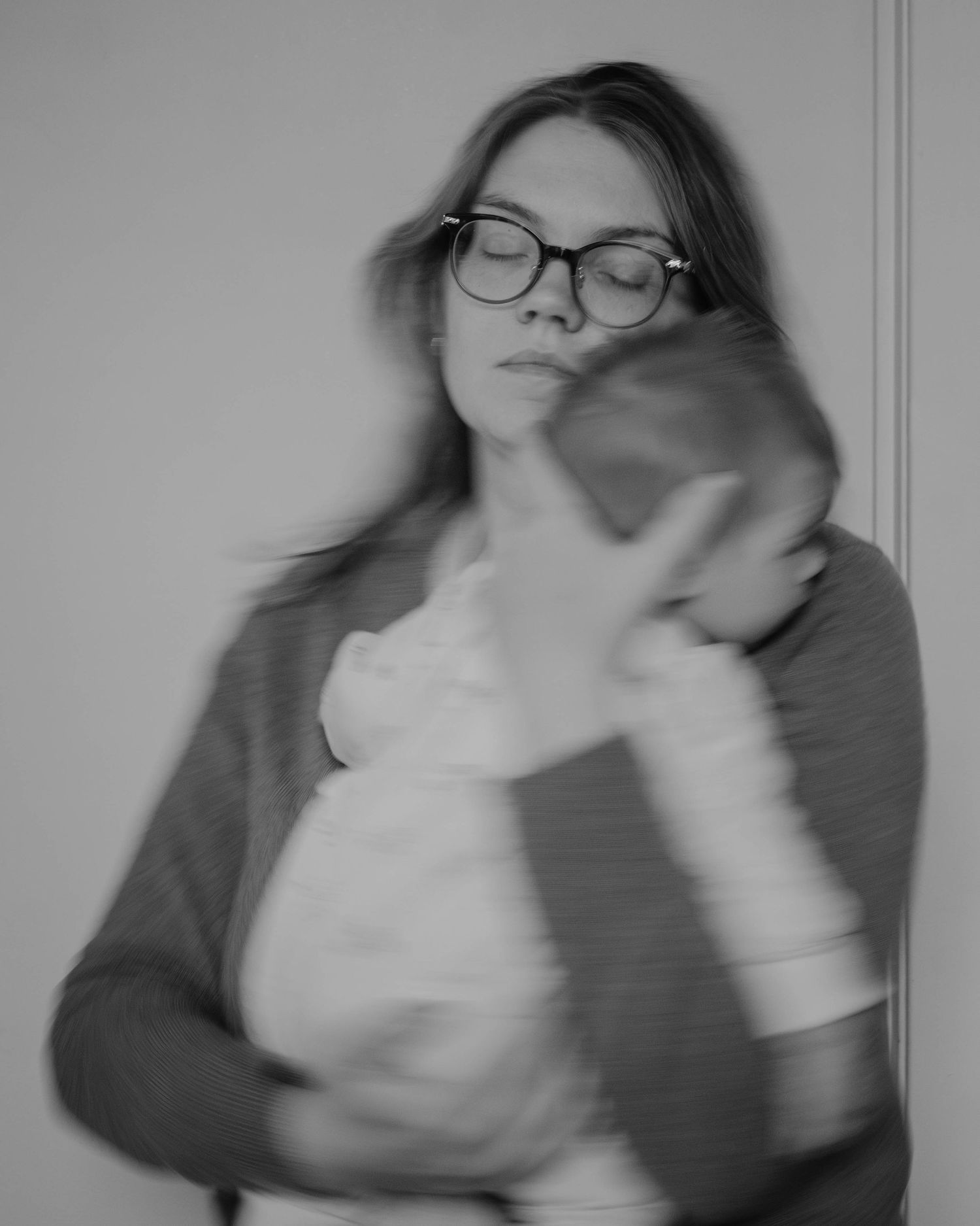 Black and white photo, where I am holding my infant daughter to my chest. My eyes are closed, and I am gently swaying side to side.