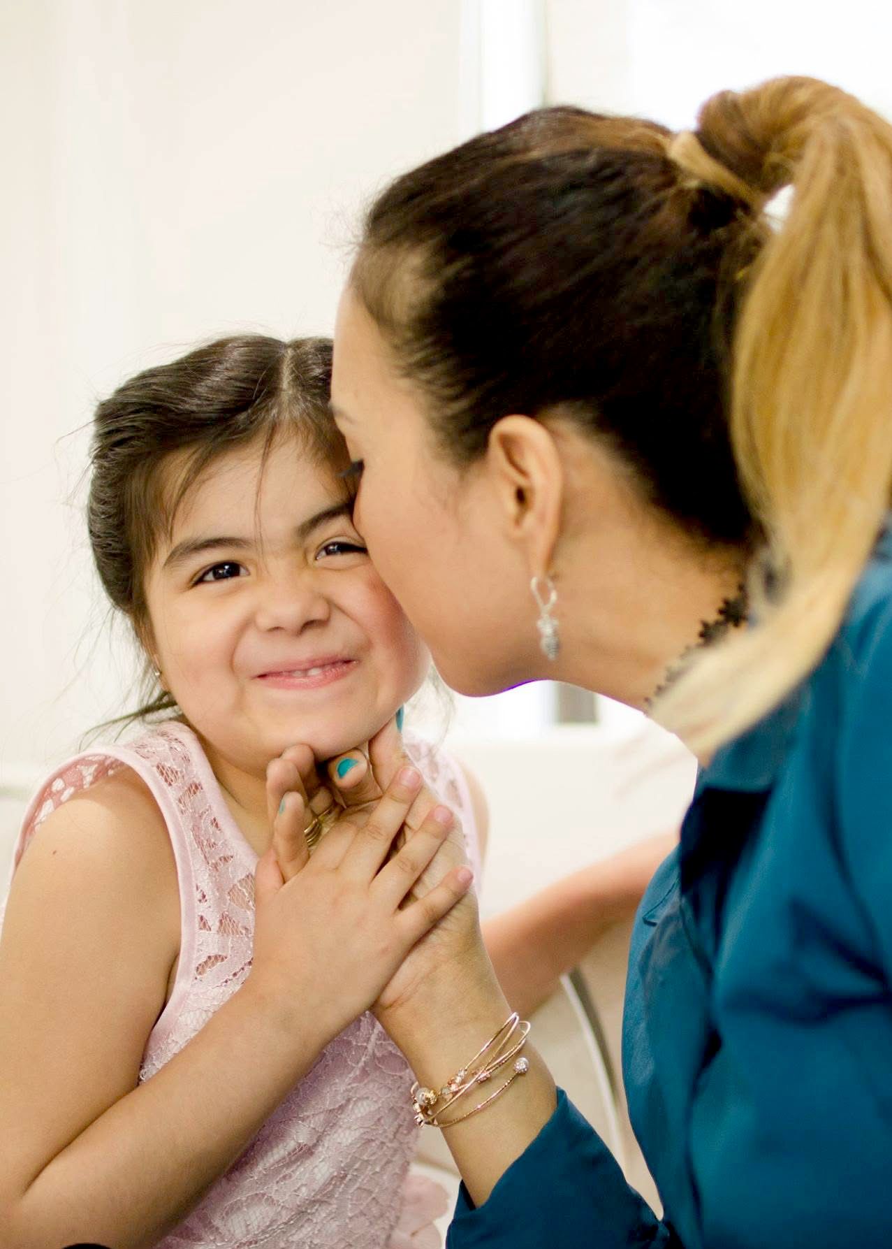Sweet moment captured between parent and child with joyful expressions.
