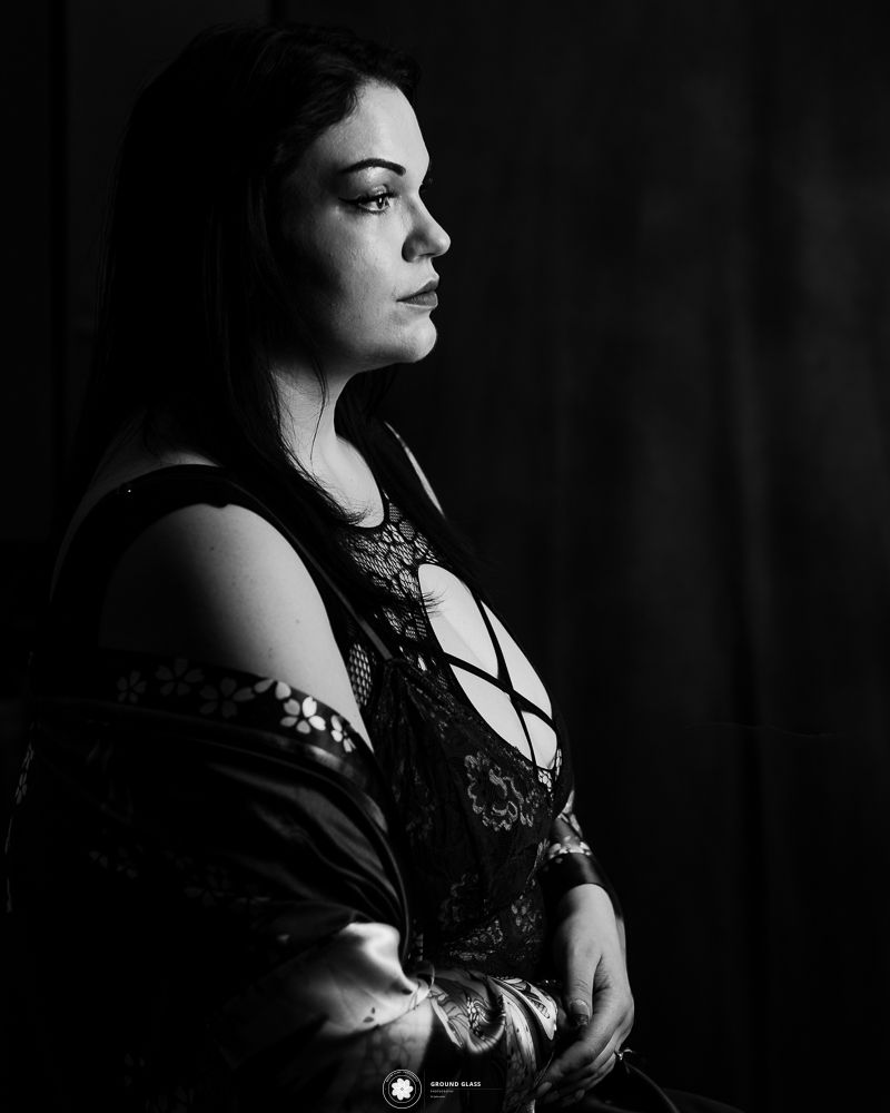 Black and white editorial boudoir portrait of a tattooed woman with arms crossed — Ground Glass Photography, Kent, Washington