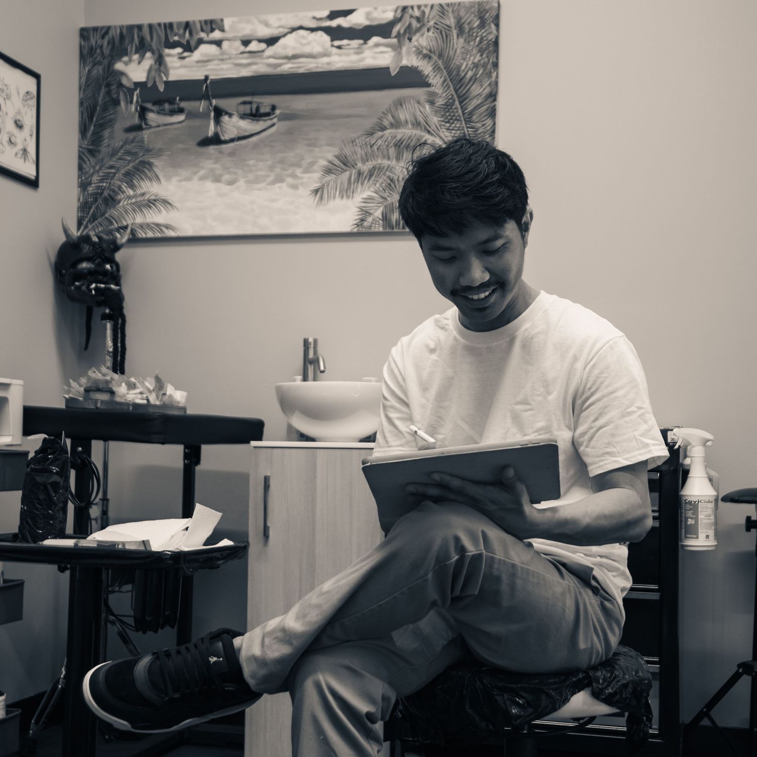 Black and white documentary portrait of tattoo artist Juan Nangkil at work in his studio — Ground Glass Photography, Kent Washington