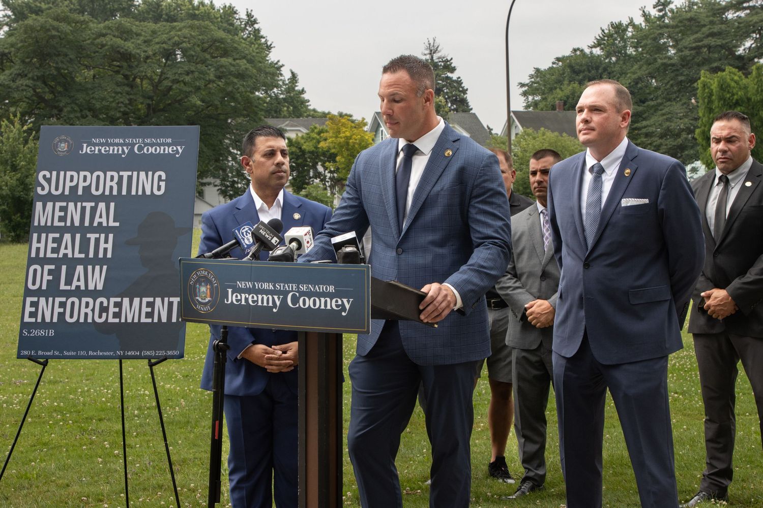 Officials at outdoor press conference supporting mental health of law enforcement.