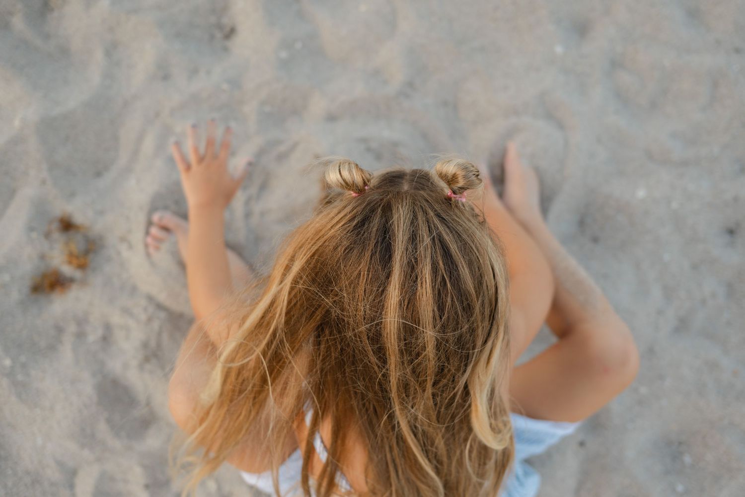 Candid artful image of child playing at the beach in Palm Beach Florida.