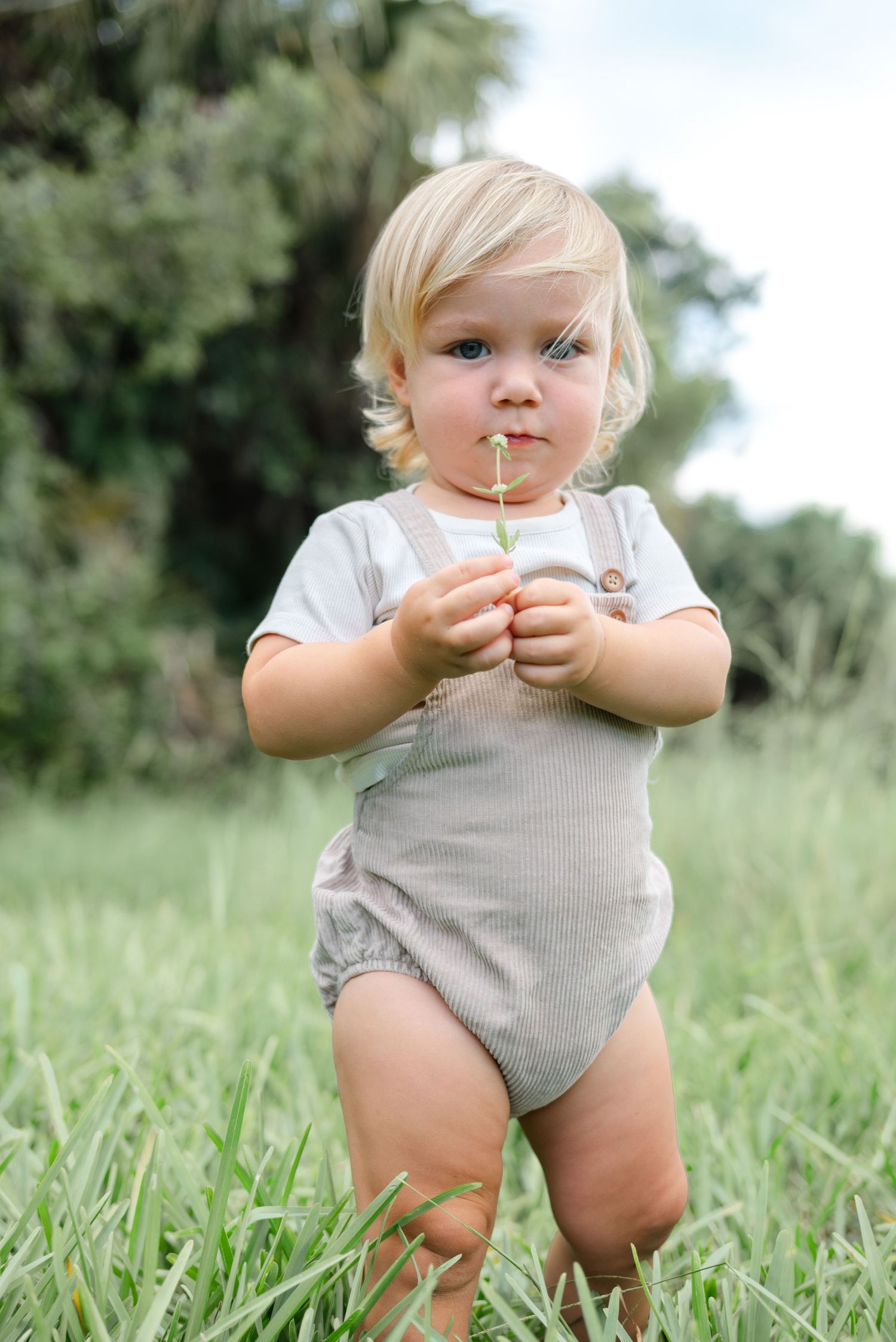 A beautiful photo of a child at golden hour in a field in West Palm Beach Florida.