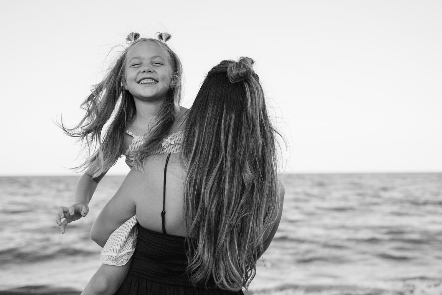 A timeless natural photo of a mother and daughter at Palm Beach Municipal Beach FL.