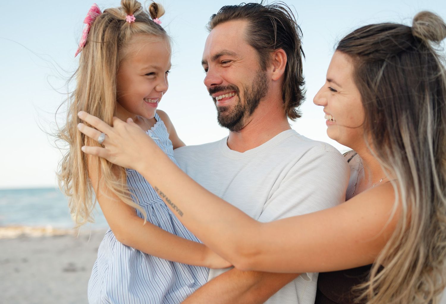 A sweet family naturally posed at Sunrise Beach in Palm Beach Florida.