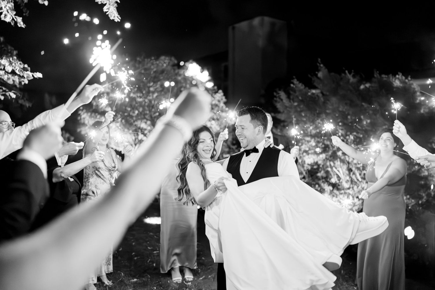 A joyful wedding dance with flowing white fabric twirling in multiple candid black and white photo frames.