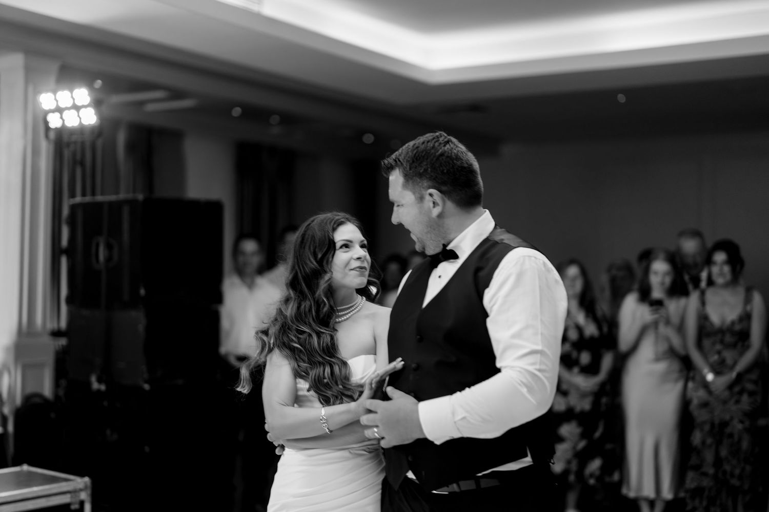 Black and white wedding photo collage showing couple dancing together during an intimate reception celebration.