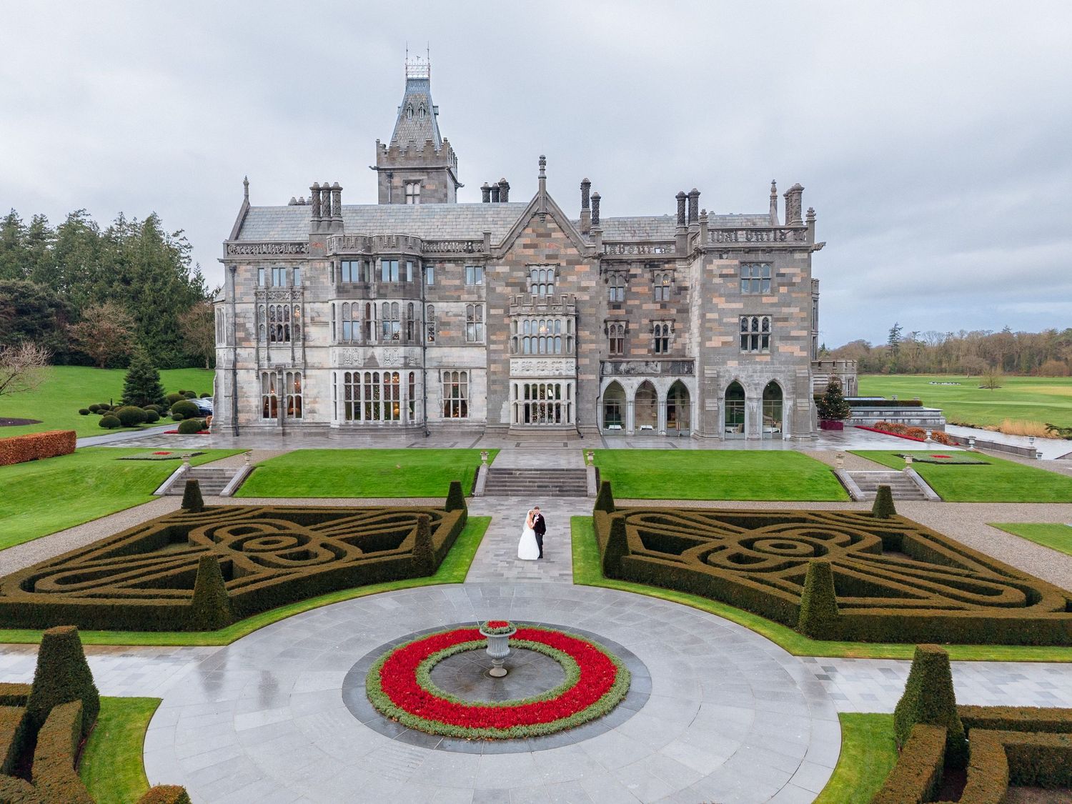 Aerial view of Adare Manor Hotel showcasing its ornate Victorian architecture and manicured garden. Adare Manor Wedding Photos by Sarah Kate