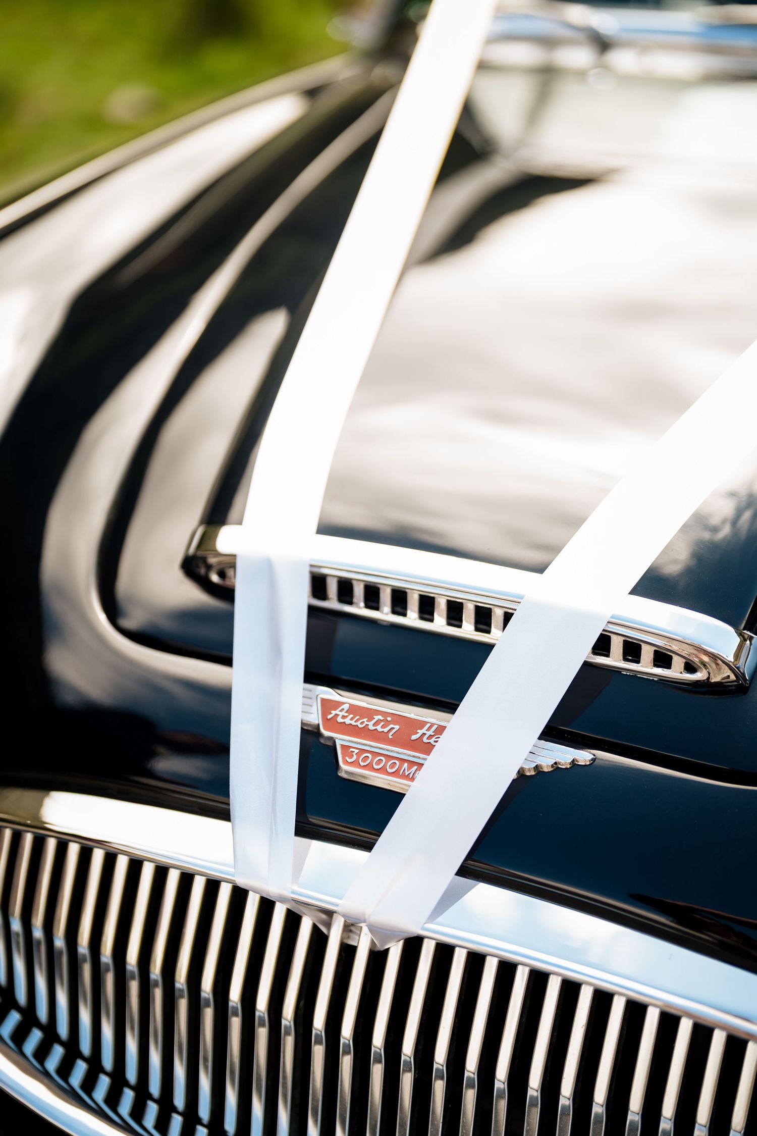 Abstract series showing chrome car grill details with repeating diagonal lines and reflections.