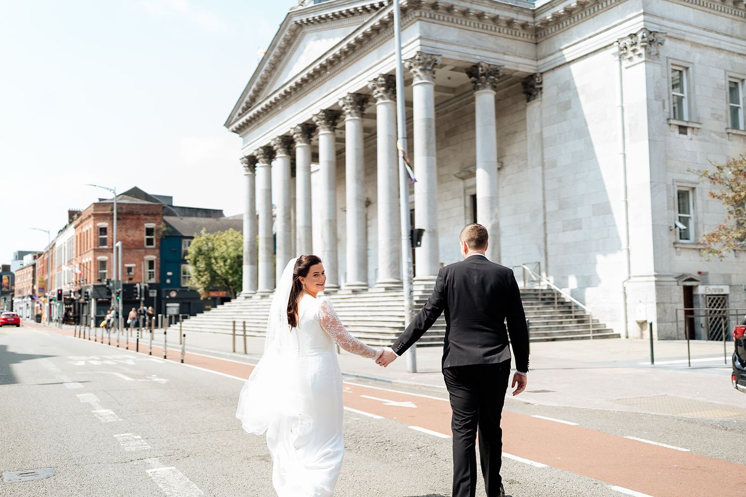 A wedding couple walks in Cork City