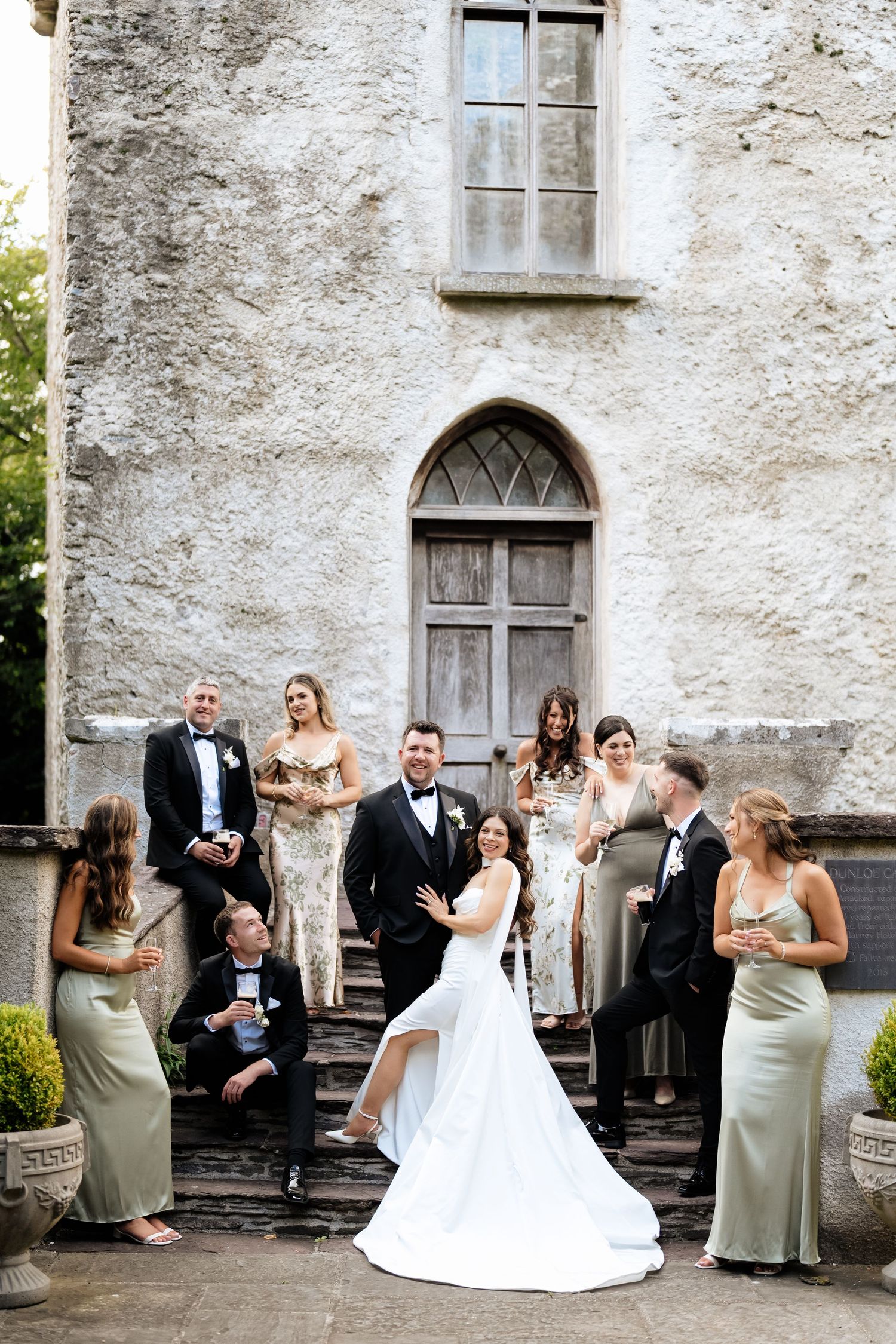 A sequence of wedding party candids showing joyful moments outside a rustic stone building with white walls and windows.
