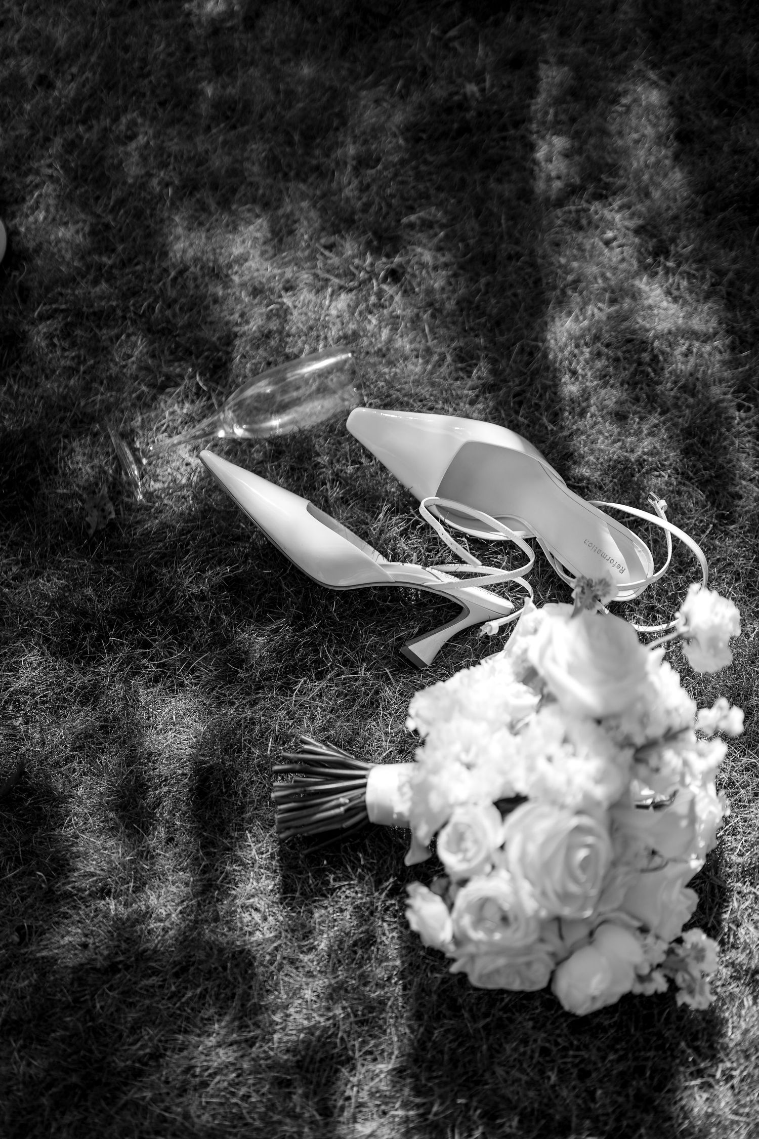 A sequence showing a rolled up white flower bud gradually opening into a beautiful white blossom against a dark background.