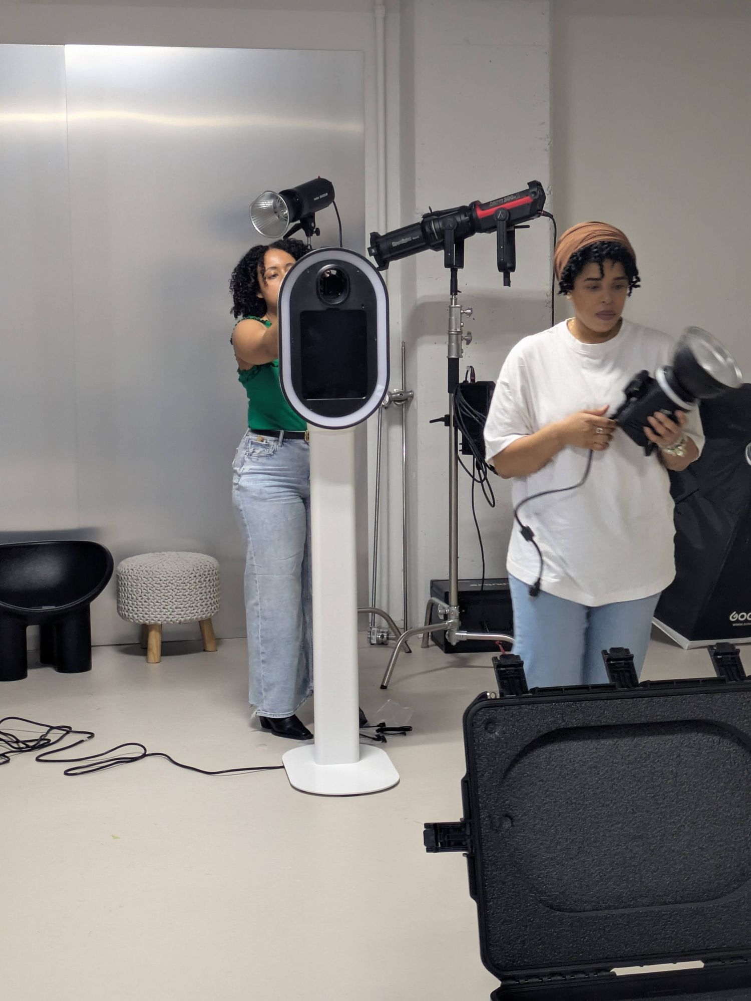 Behind-the-scenes photo shoot setup showing camera equipment and lighting in a studio.