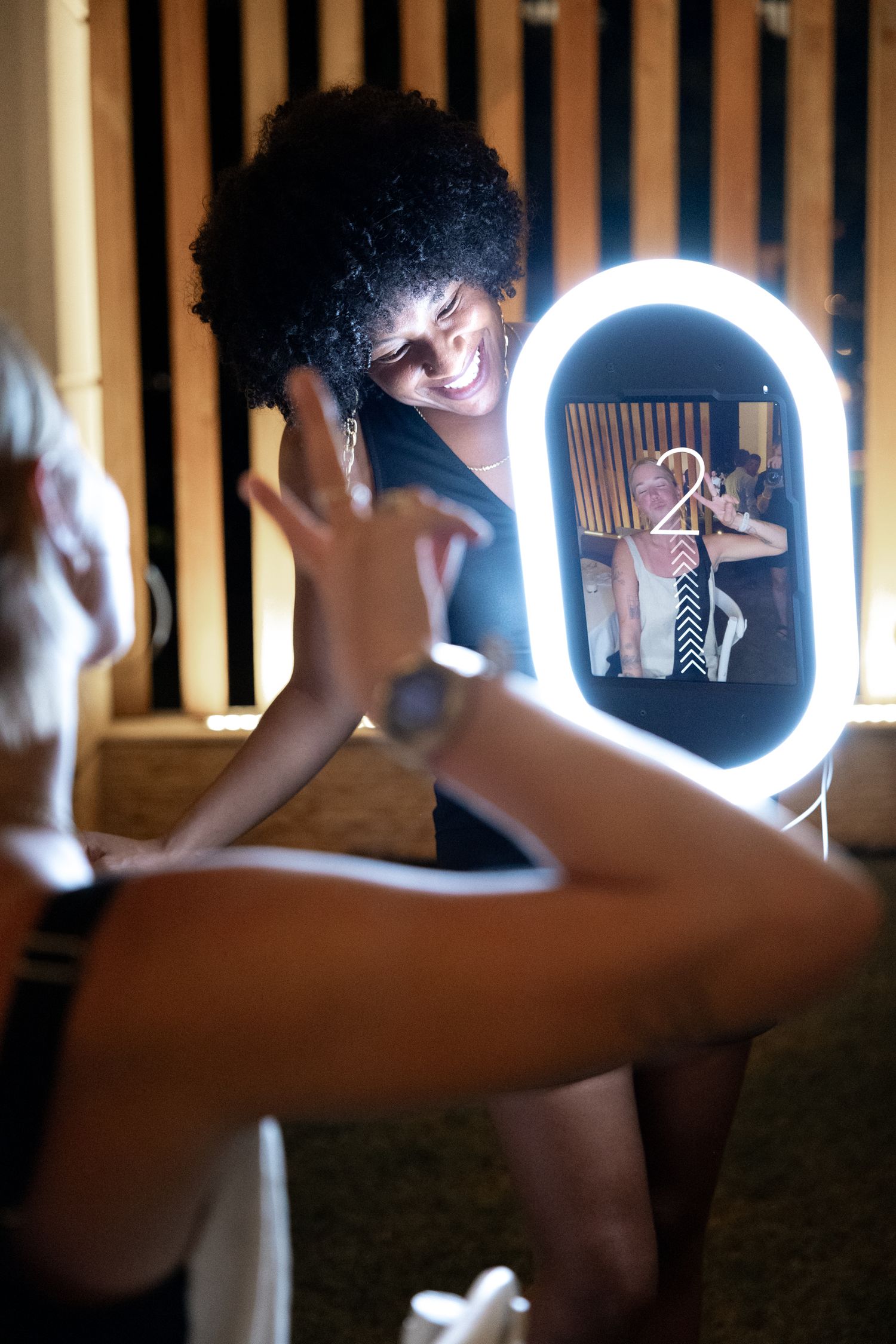 A sequence of artistic silhouette photos showing a figure posing with a glowing circular ring light in a dark setting.
