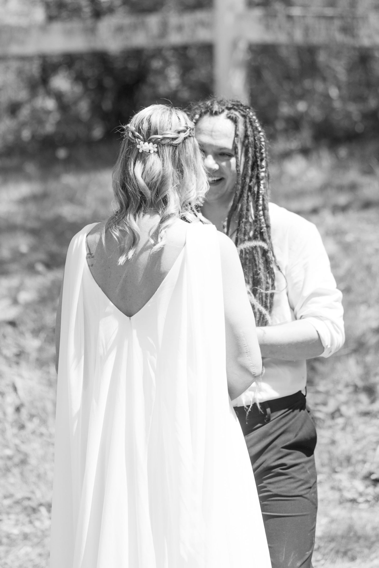 A black and white photo of a couple sharing their first look on their wedding day in Adel, Iowa.