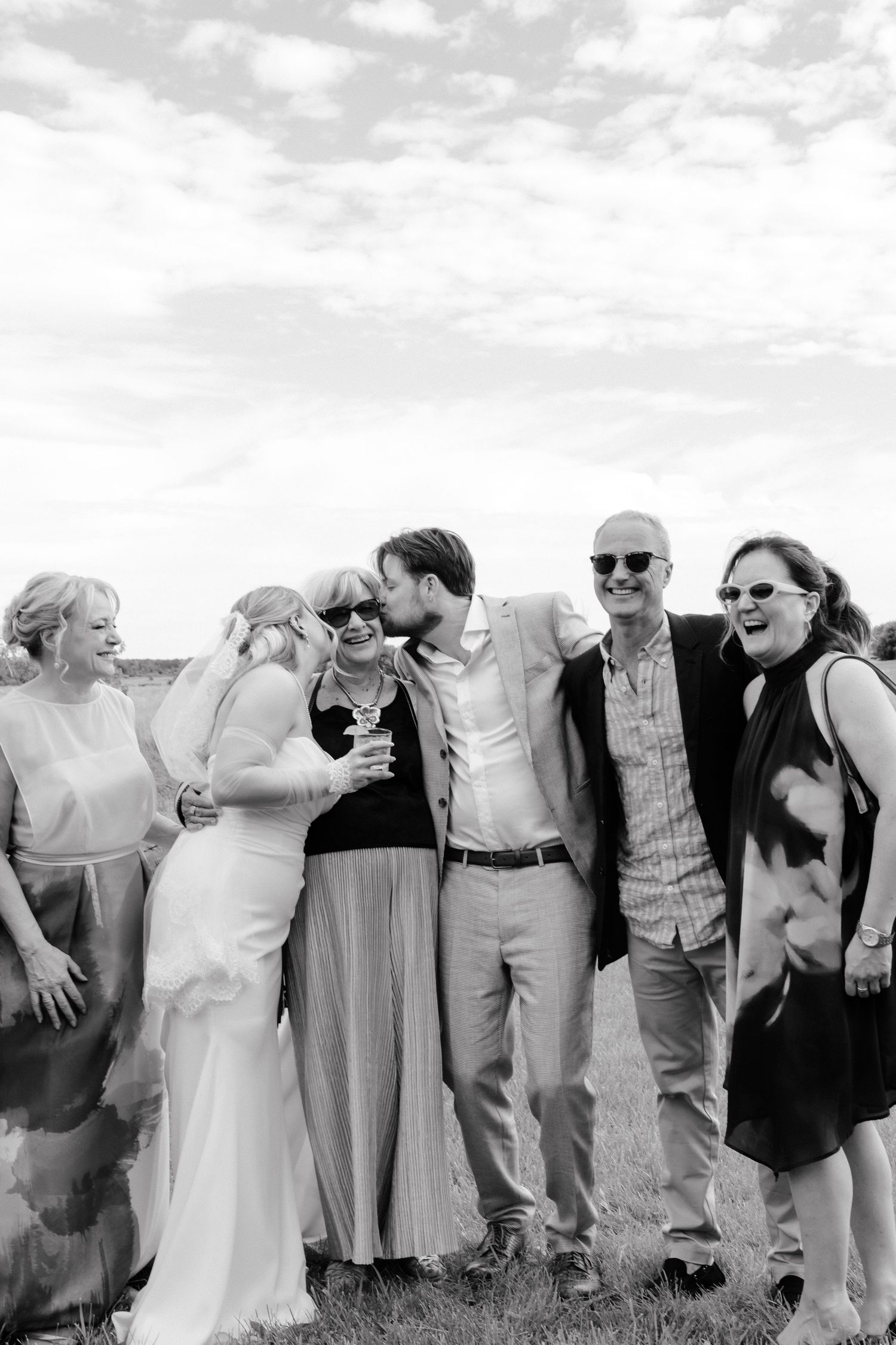 Editorial, classic and elegant shot of newlyweds with family