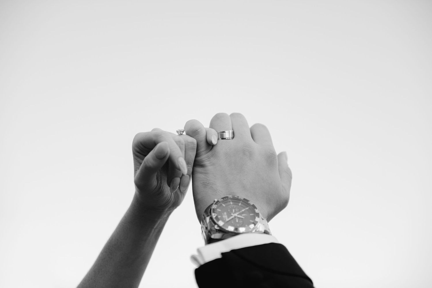 black and white editorial shot of bride and groom's hands with rings. Shot in Ottawa by Veronique Jones Montreal and destination wedding pho