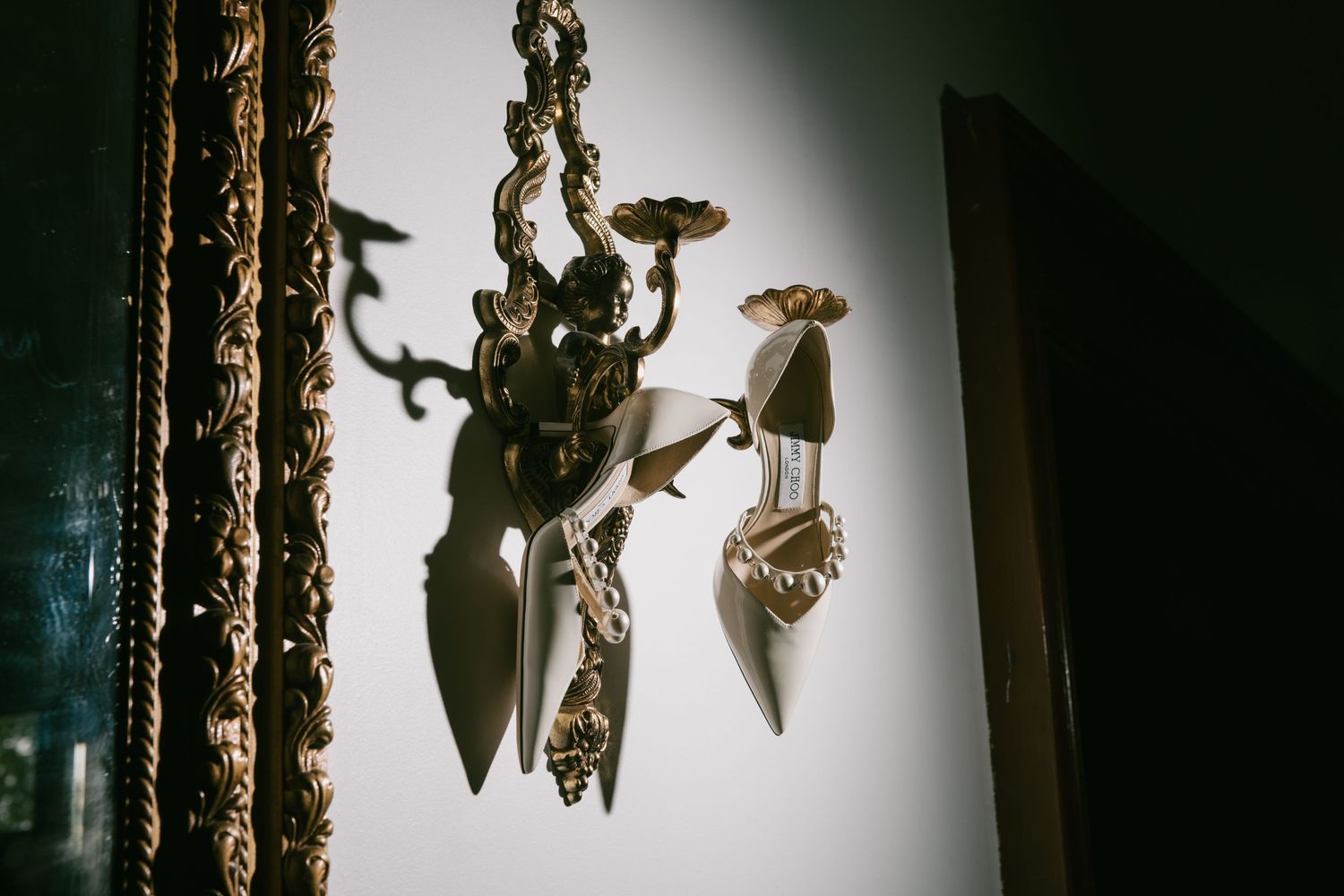 Destination editorial wedding photographer, shot of a bridal shoes in Dramatic lighting. Moody, luxury, high end, True Tone