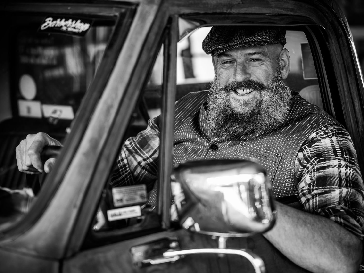 A black and white photo montage showing multiple angles of someone seated in a vehicle's driver seat.