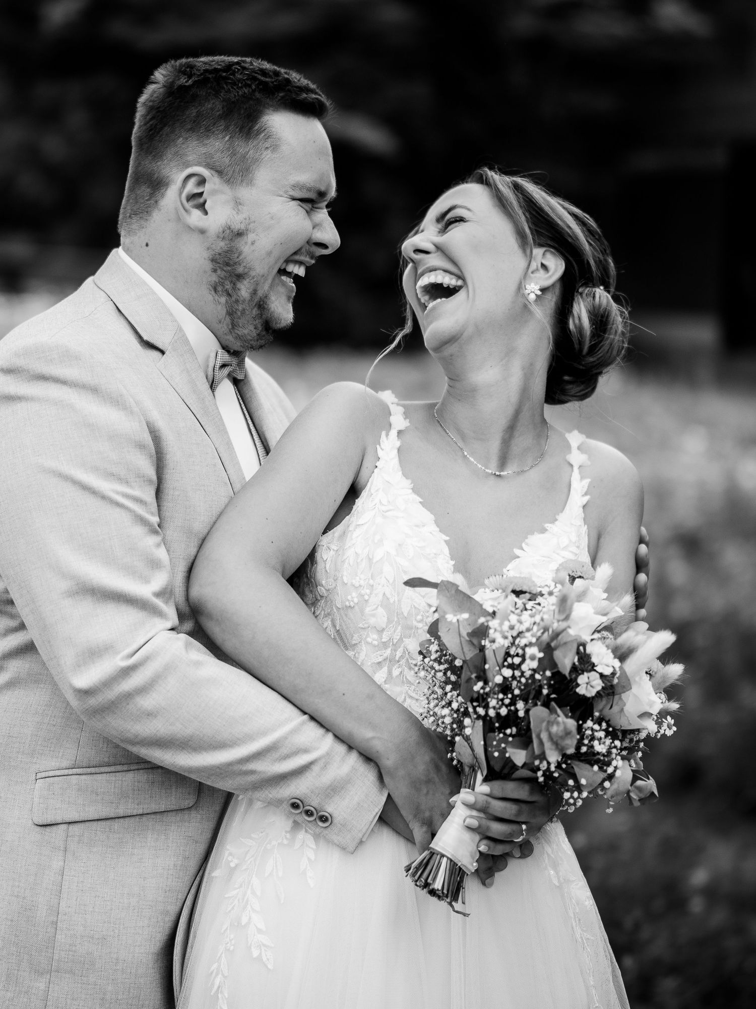 A romantic black and white wedding photo series showing tender moments between newlyweds with a white dress and bouquet.