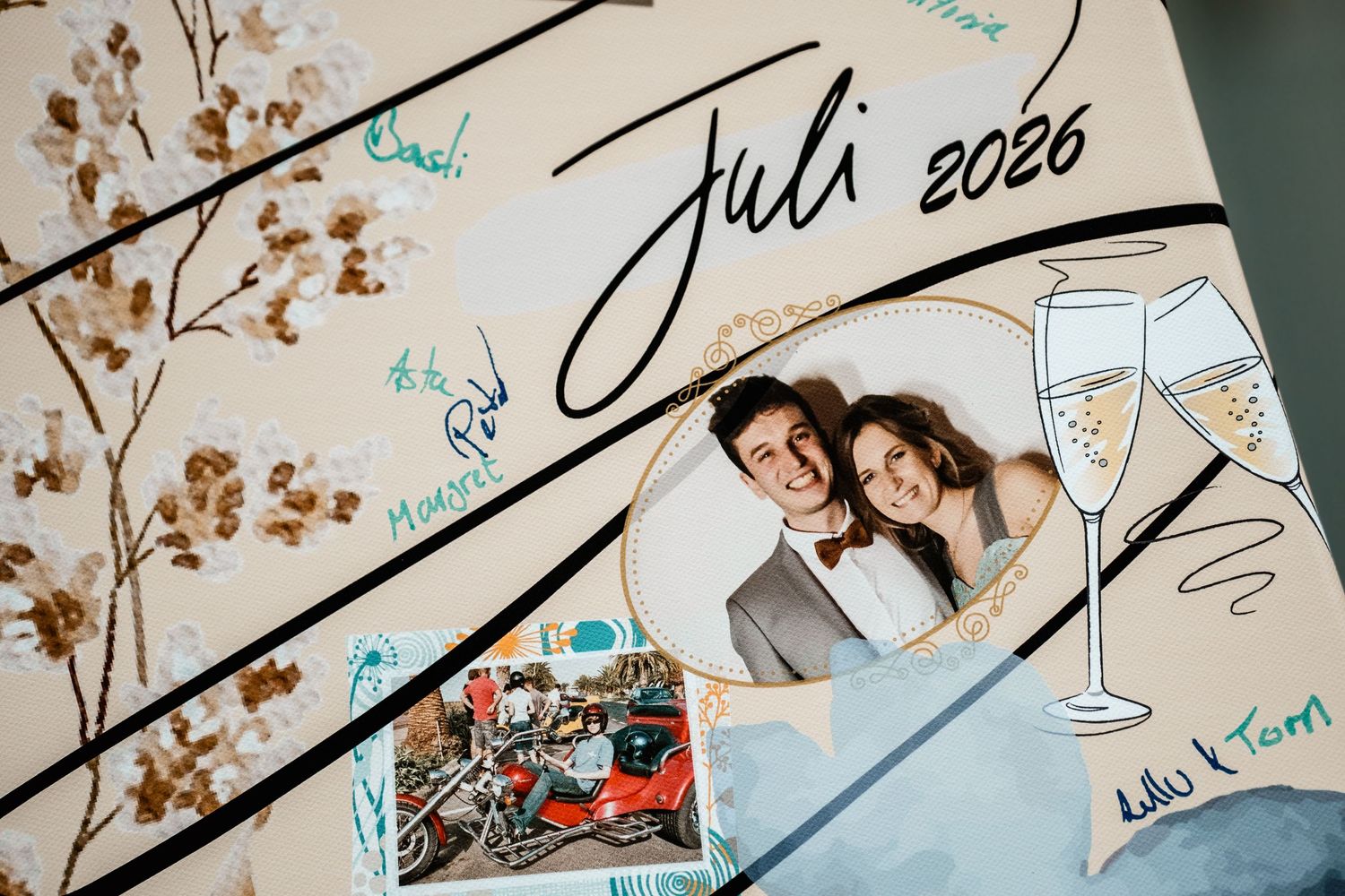 Wedding guest book artwork featuring a couple photo and Juli 2026 date with champagne glass illustrations.