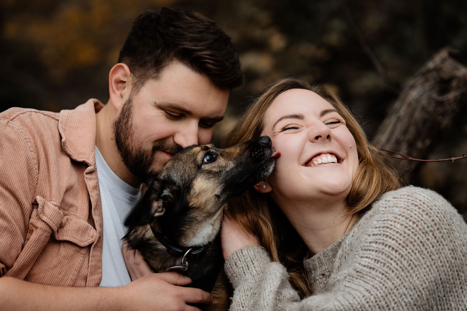 A romantic couple embraces outdoors in a series of intimate poses while wearing casual fall attire.