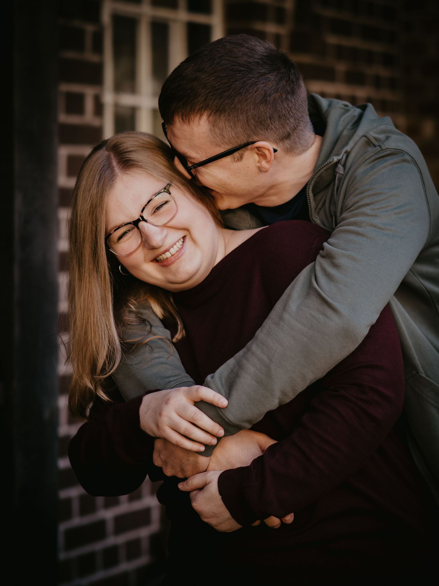 A couple shares intimate embraces and laughter in a series of romantic dark-toned photos.