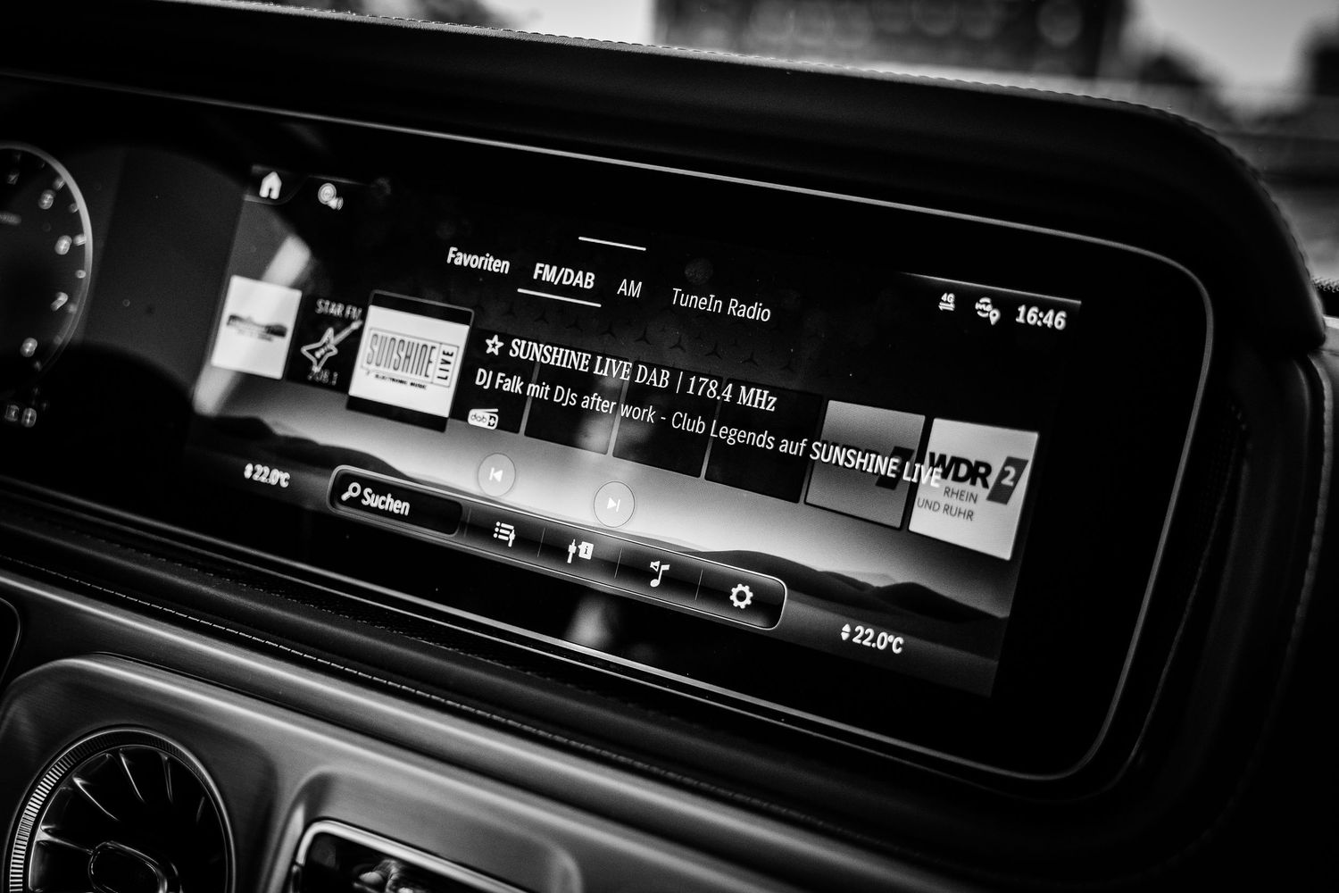 Black and white close-up of a Mercedes-Benz G-Class infotainment screen displaying DAB+ radio tuner.