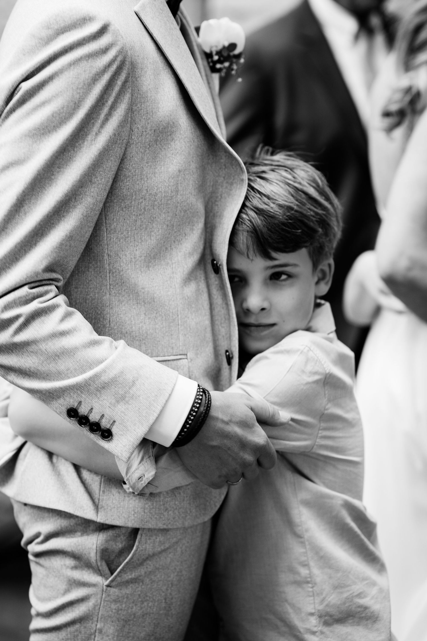 Black and white photo series showing a child hugging an adult's waist in a tender emotional moment.