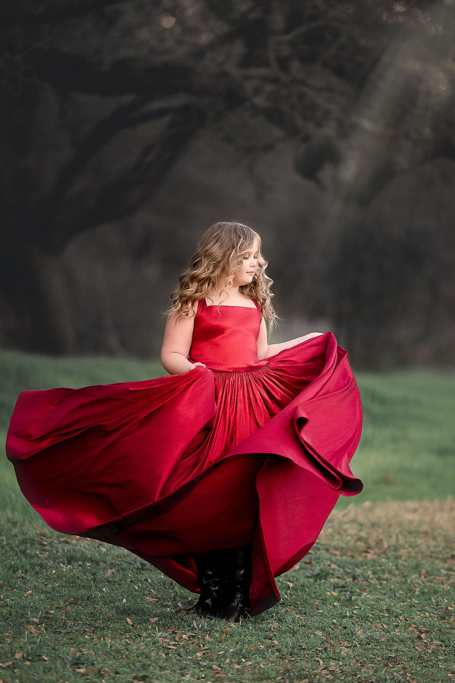 Preteen girl twirling in a red gown