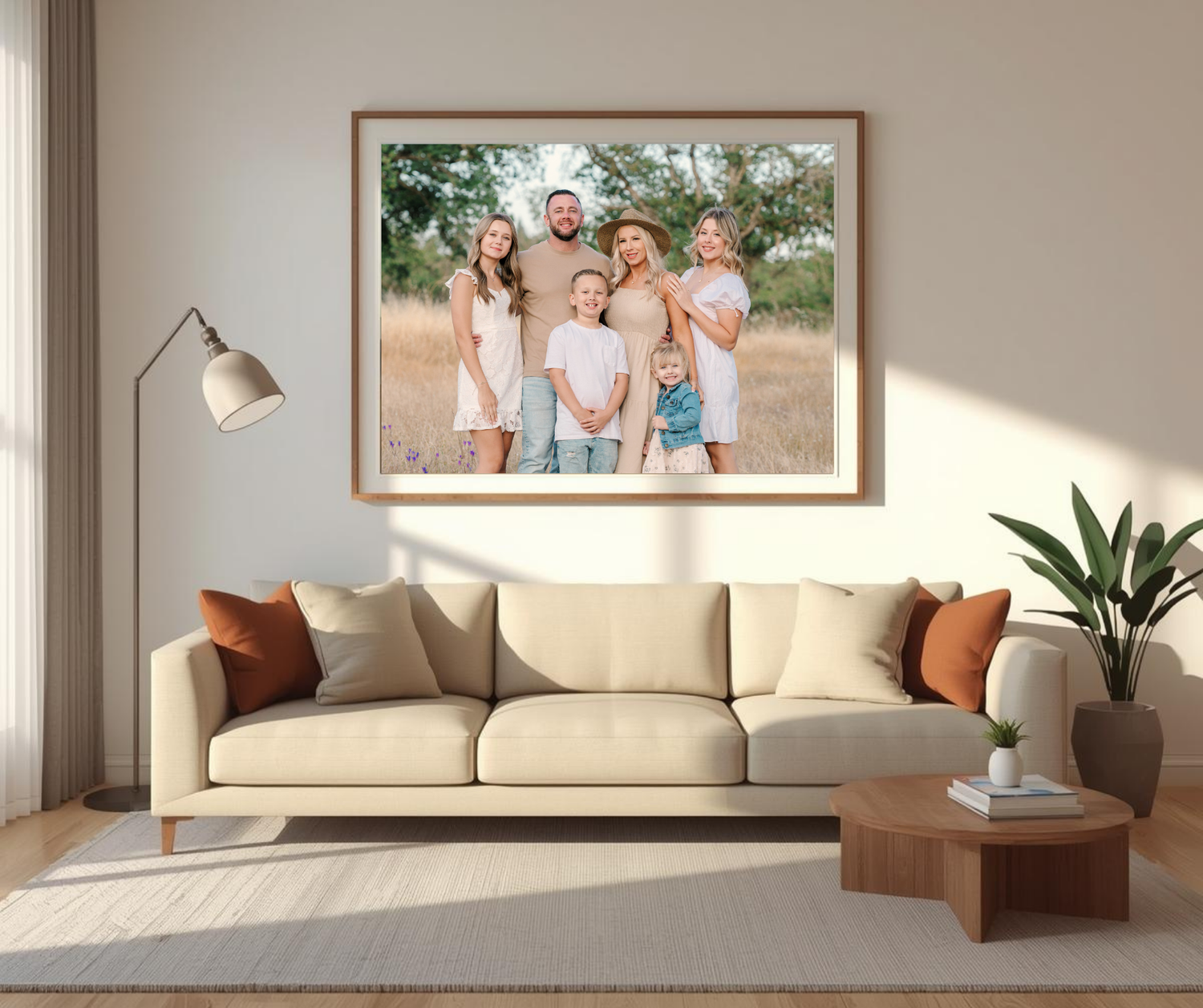 A living room with a couch and a large framed family picture about the couch.