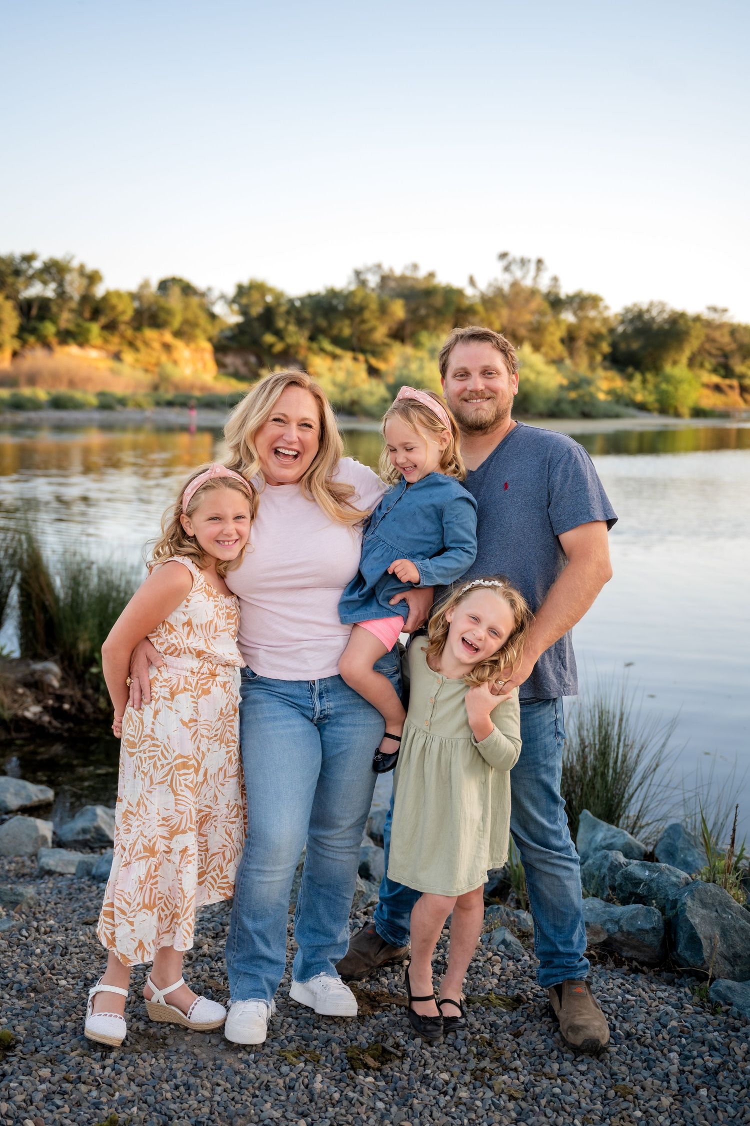 Family of Five laughing and standing on the banks of the American River at Sailor Bar County Park in Fair Oaks, California