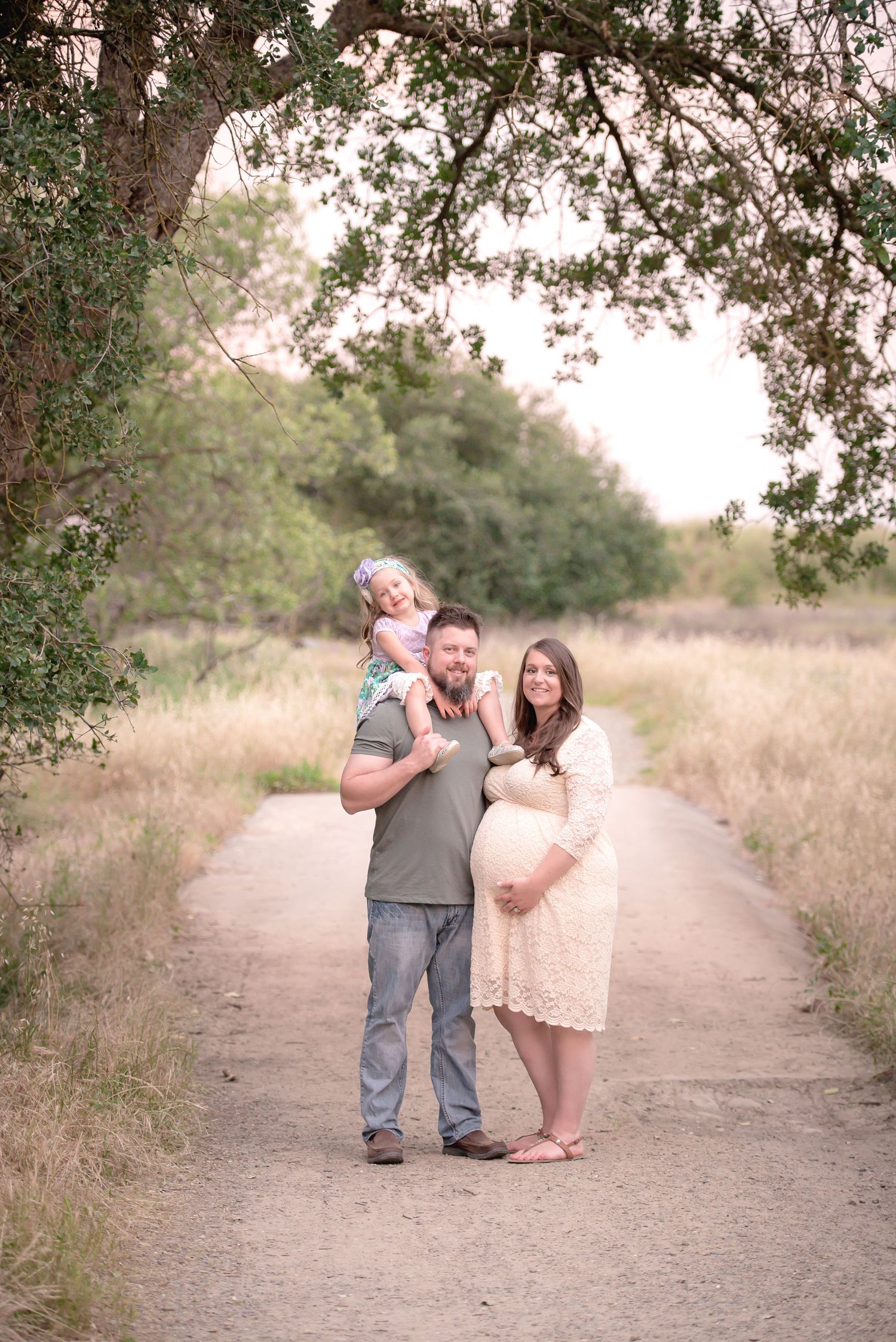 Family photo taken at Sailor's Bar County Park in Fair Oaks, California.  The mom is pregnant and the dad has young girl on his shoulders