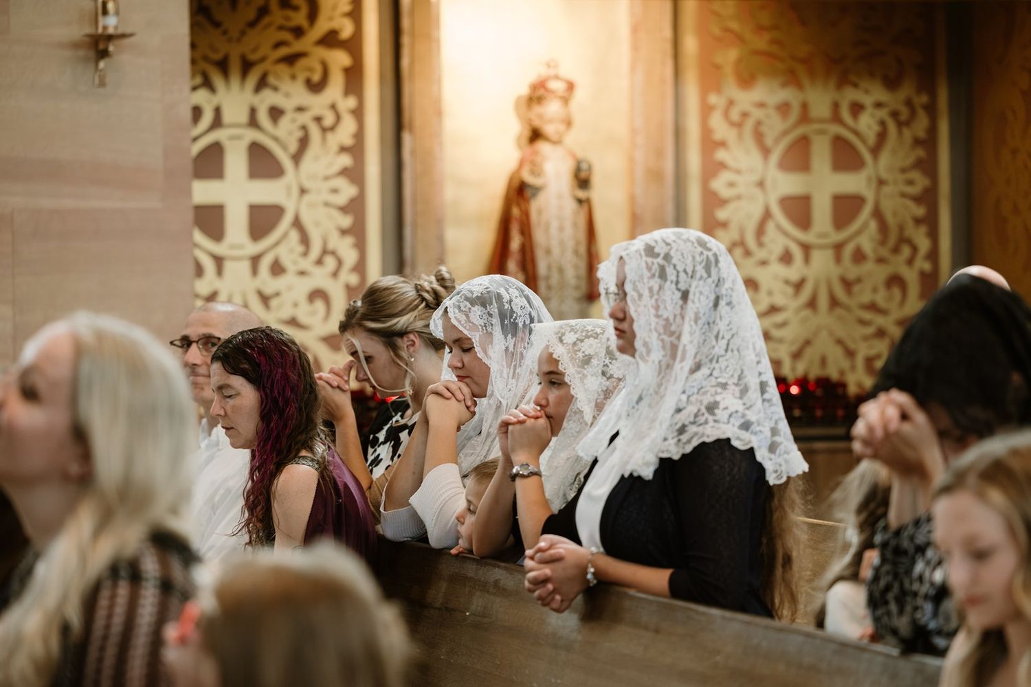 Wedding guests wave white handkerchiefs during a joyous celebration at an elegant reception venue.