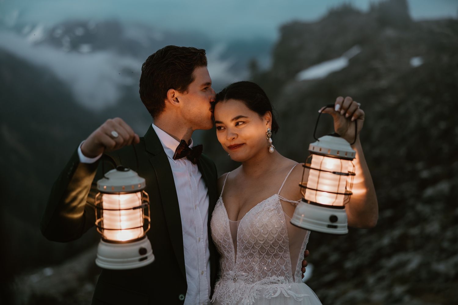 Adventure elopement photographer capturing a couple in the mountains of Washington at twilight with lanterns