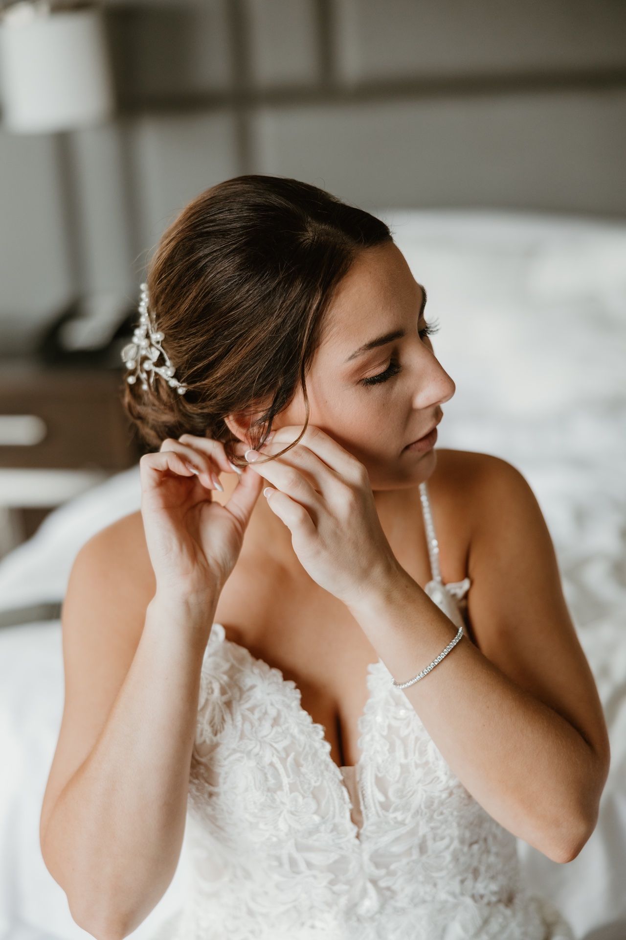 wedding photographer in Minneapolis capturing a bride putting on her earrings.