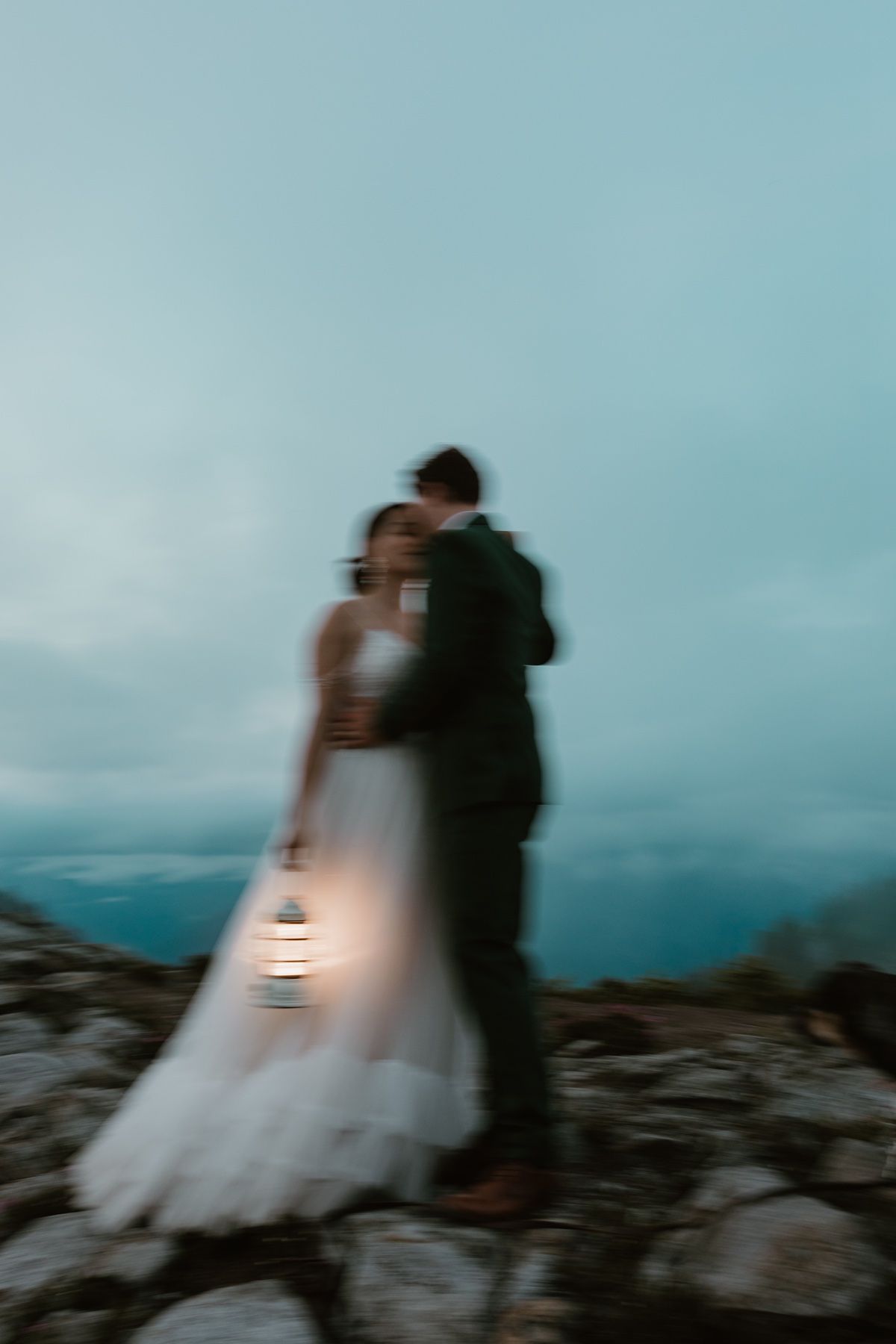 Adventure elopement photographer documenting a quiet moment between a couple in the mountains