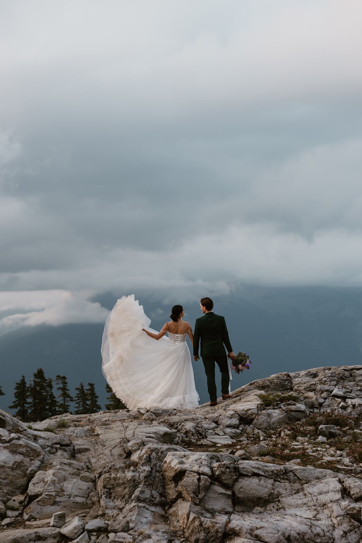 Bride plays with dress on the top of a mountain at Artist's Point in Mount Baker Washington