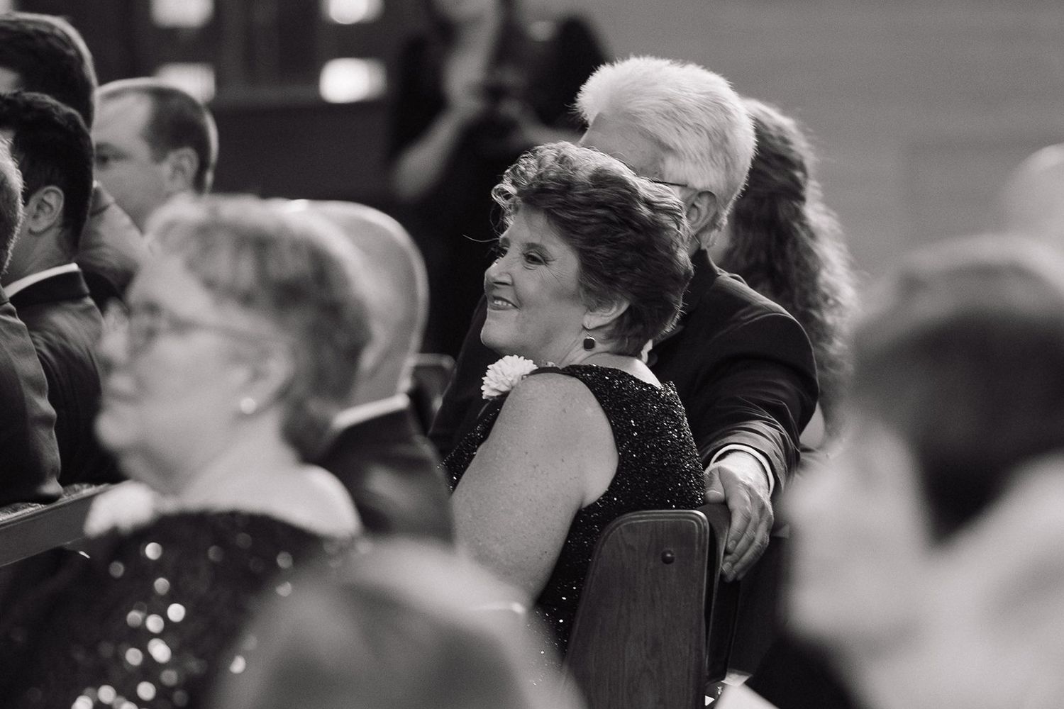 Black and white photo of audience members watching intently.
