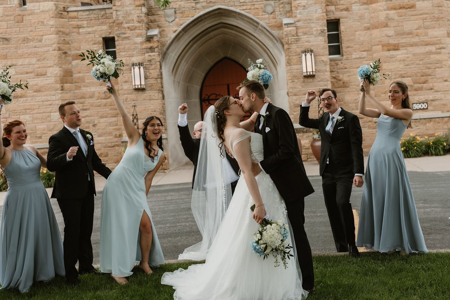 Wedding party portraits in front of Holy Family Catholic Church in St. Louis Park, MN