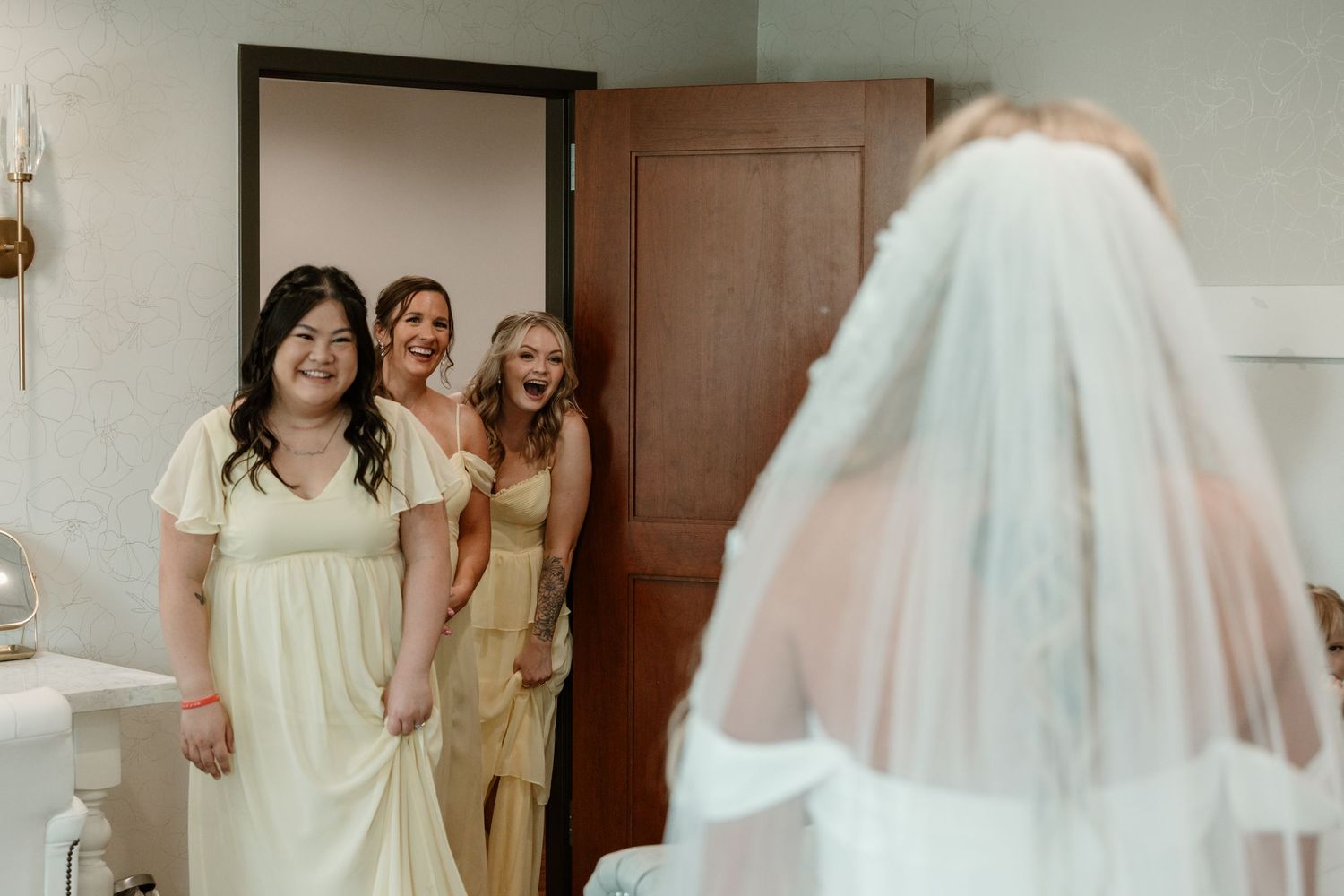 A series of bridal preparation moments showing a wedding dress, veil, and joyful interactions in a getting ready room.