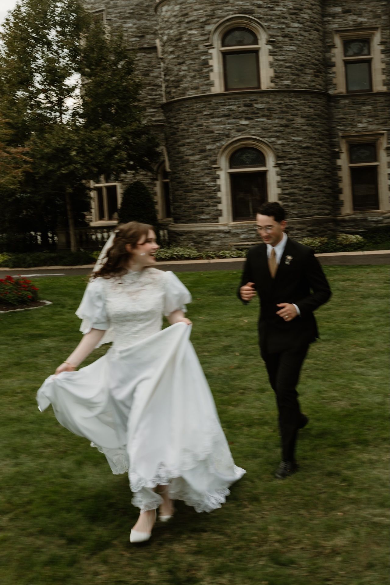 minneapolis wedding photographer capturing lighthearted photo of couple running through a park
