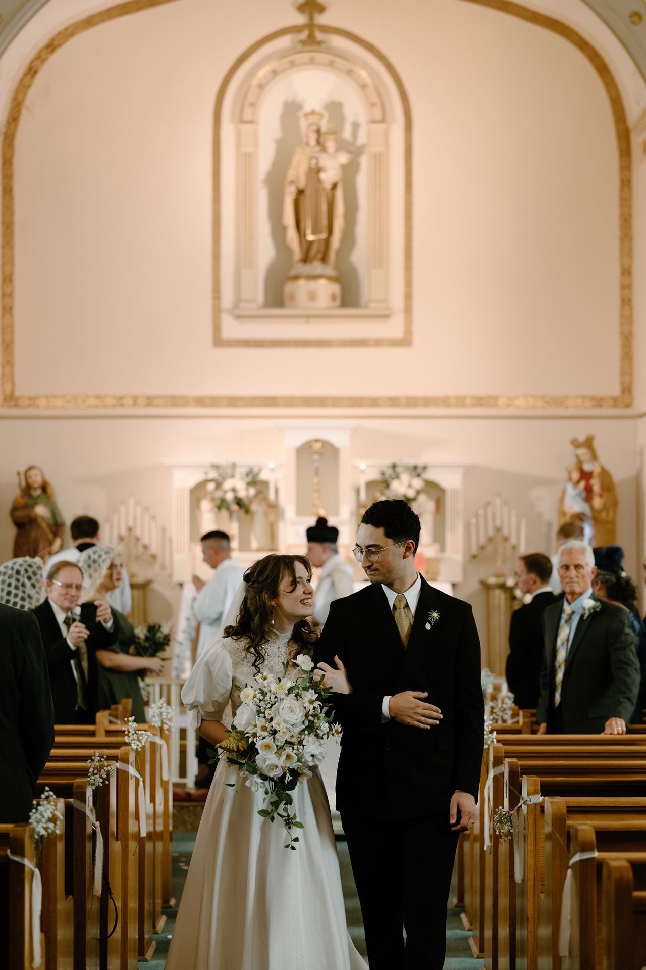 wedding photographer in Minneapolis capturing candid ceremony moments at a Catholic wedding