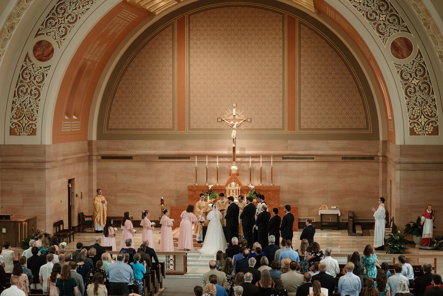 Interior of a traditional church with arched ceilings and gathered congregation during a ceremony.