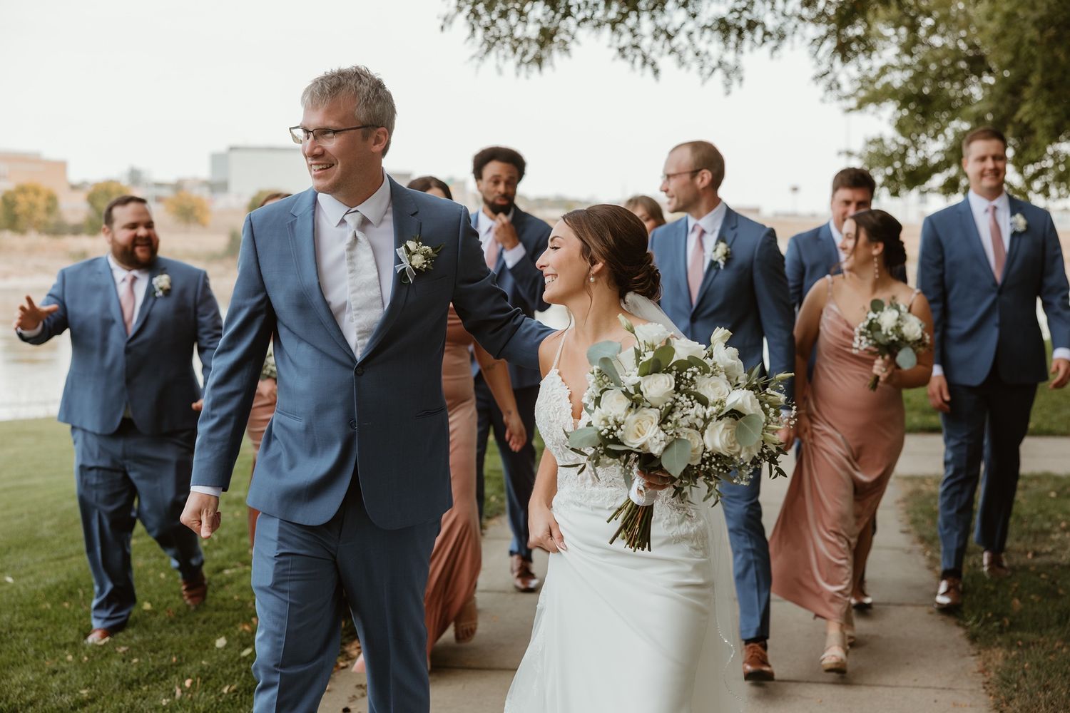 Wedding photography in Minneapolis and Beyond capturing a wedding party walking together to the ceremony