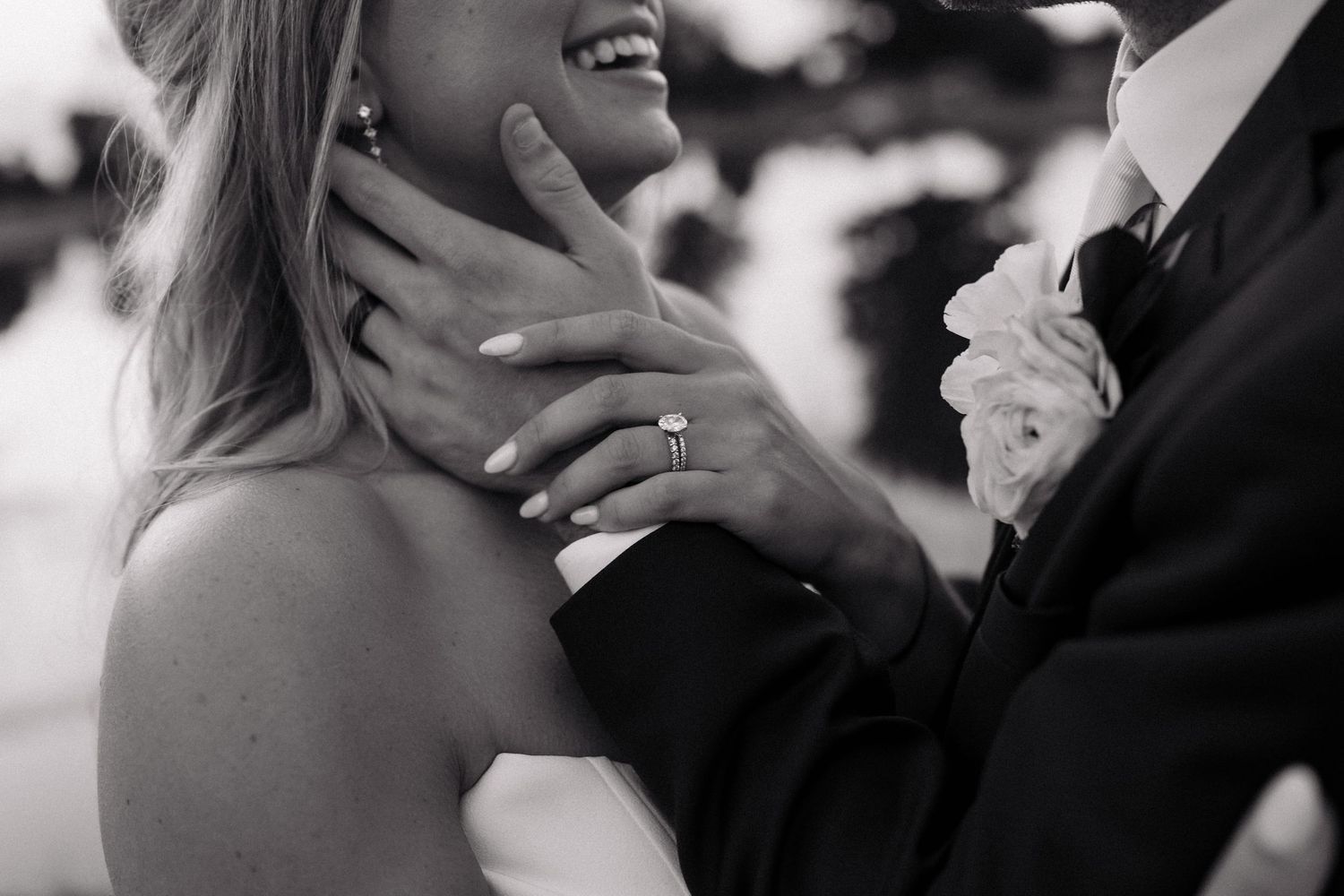 Black and white photo of a romantic couple sharing a close intimate moment during a dance at a wedding celebration.